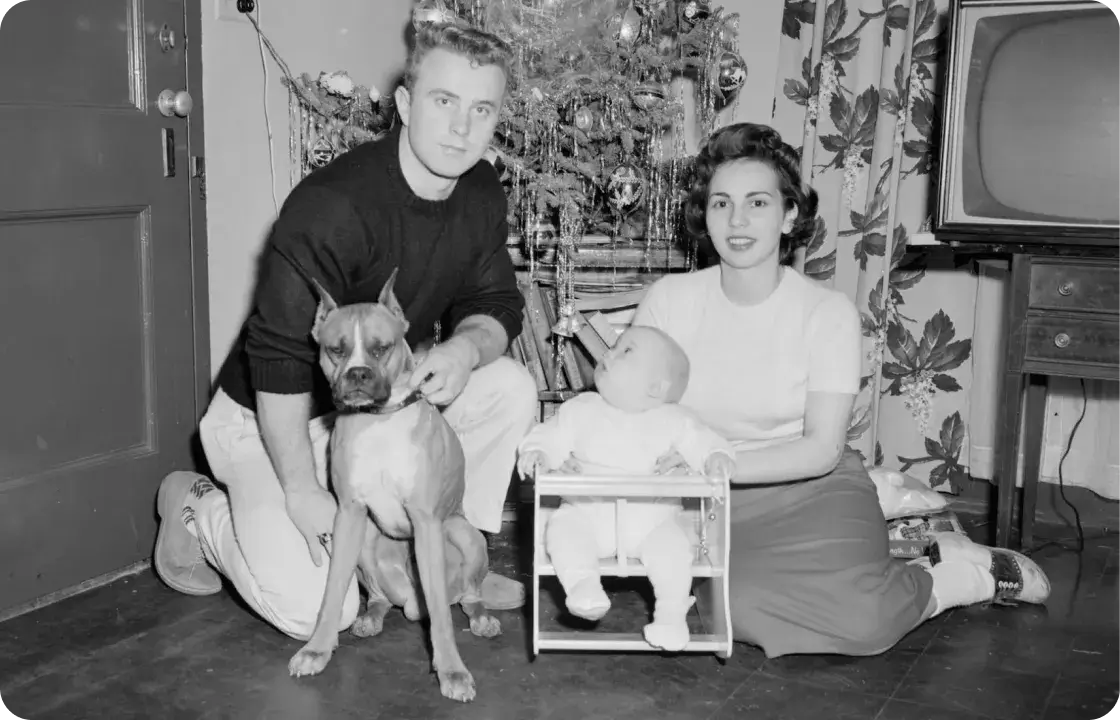 photo of of a family of three with their pets